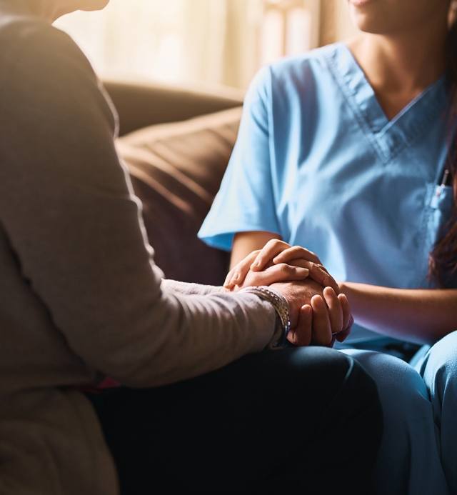 Cropped shot of a nurse holding a senior womans hands in comfort.